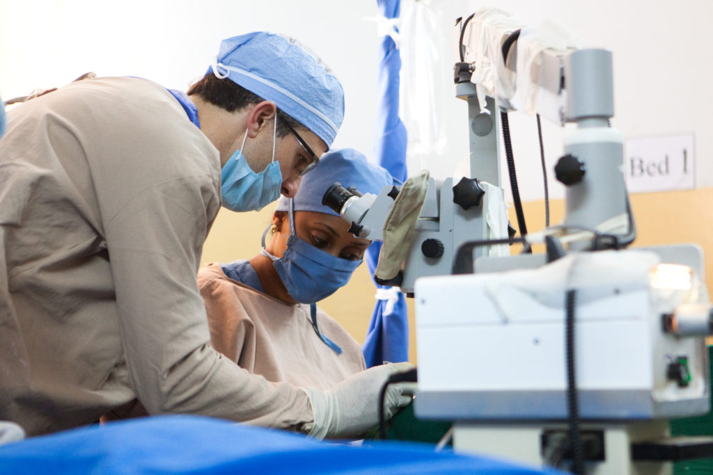 Dr. Dimmig assists one of the Ethiopian resident surgeons her first complete cataract surgery.
